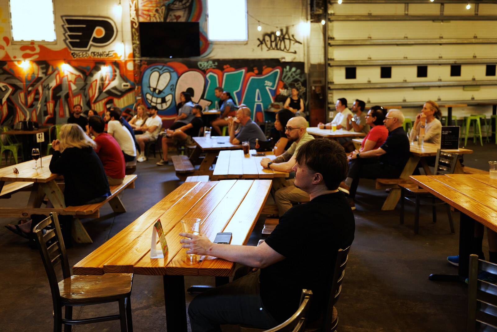 Attendees seated at Root Down's long tables before the talk