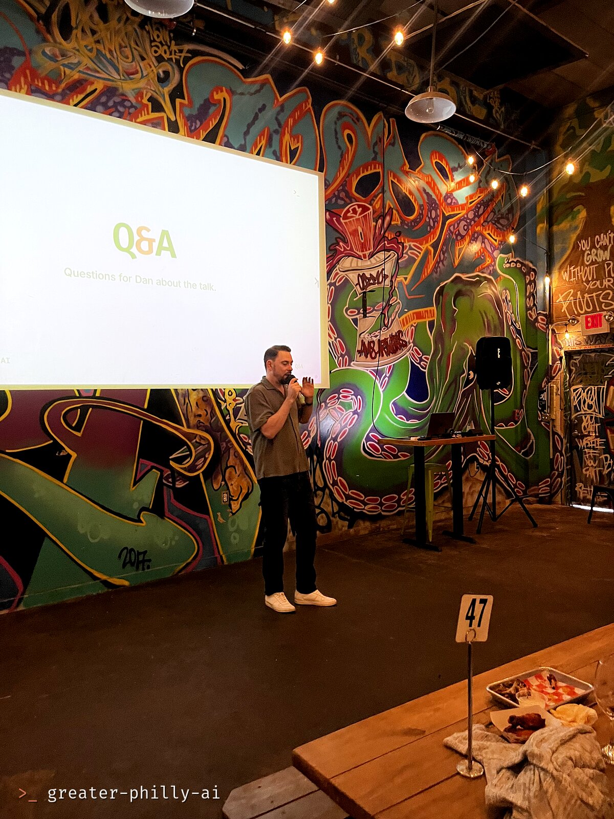 Dan taking questions in front of the Q&A slide