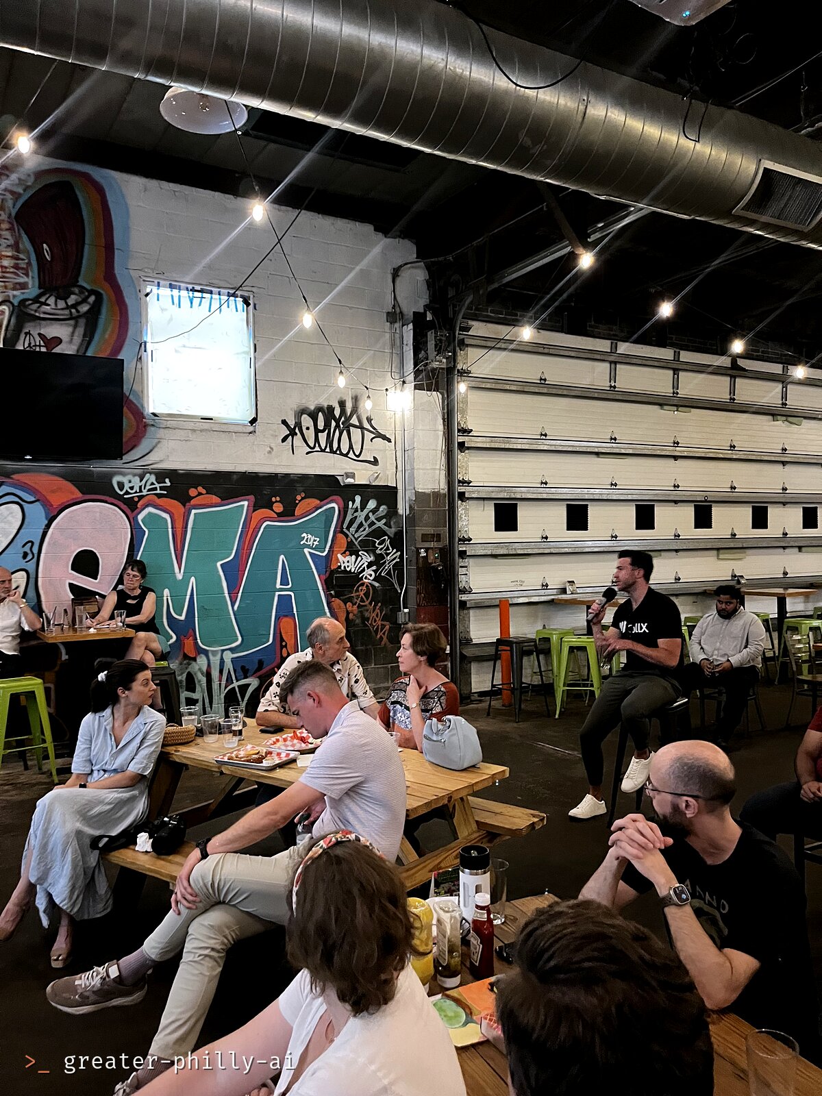 An audience member asking a question from the back of the room